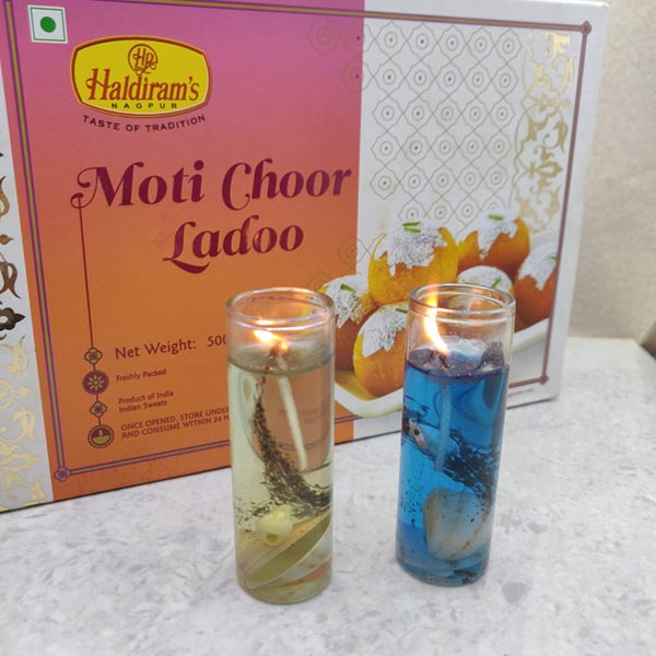 Send Tall glass candles with motichoor ladoo Online DW21100026