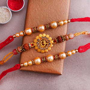 Two Pearl Rakhi with Golden Om Rakhi