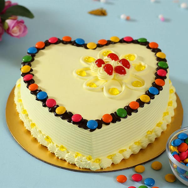 Send Butterscotch Cake in Heart Shape with Sprinkled Gems Topping Online